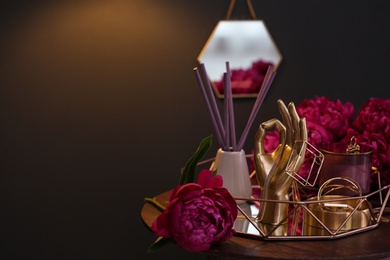 Photo of Composition with stylish accessories, flowers and interior elements on table indoors