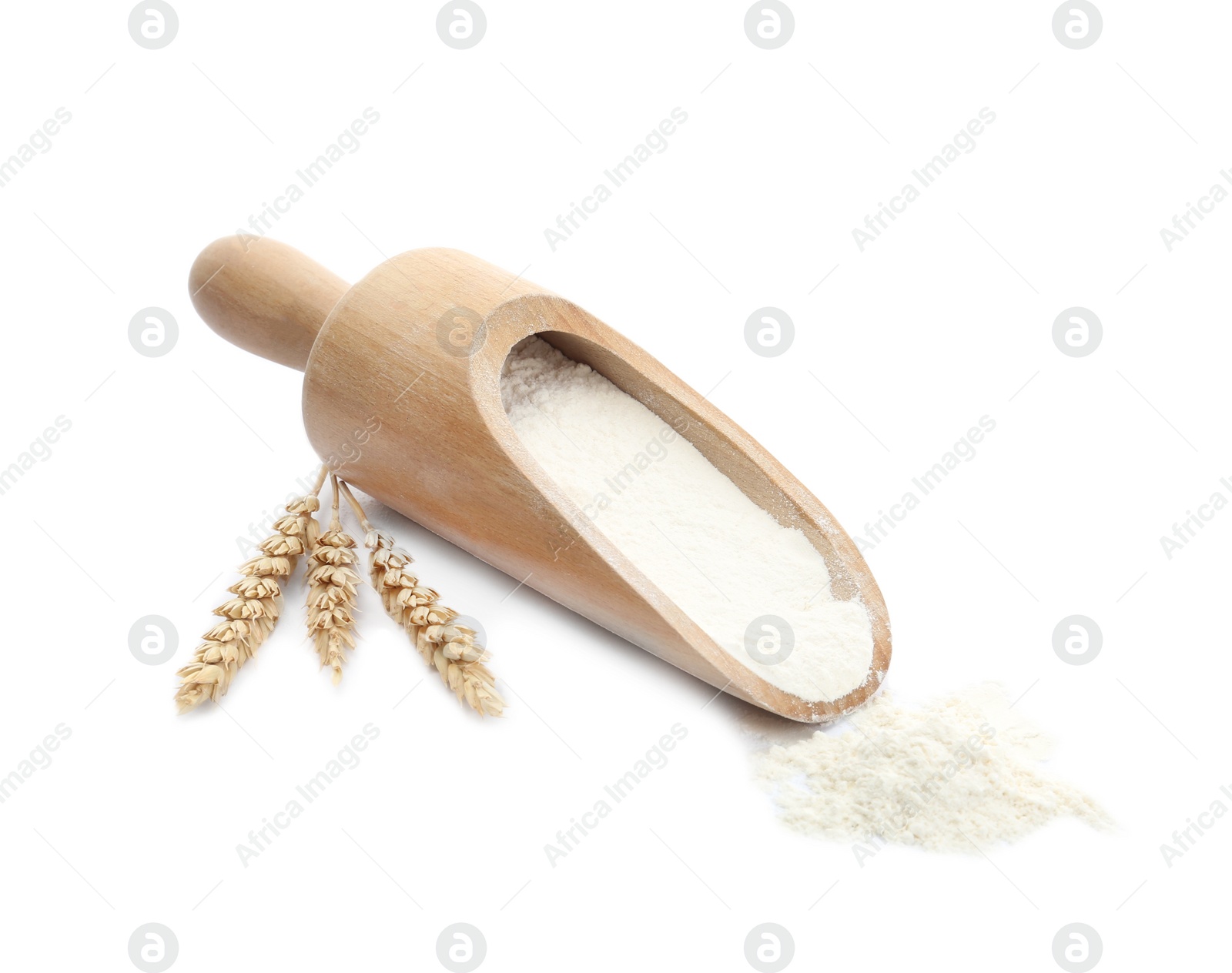 Photo of Organic flour, wooden scoop and spikelets isolated on white