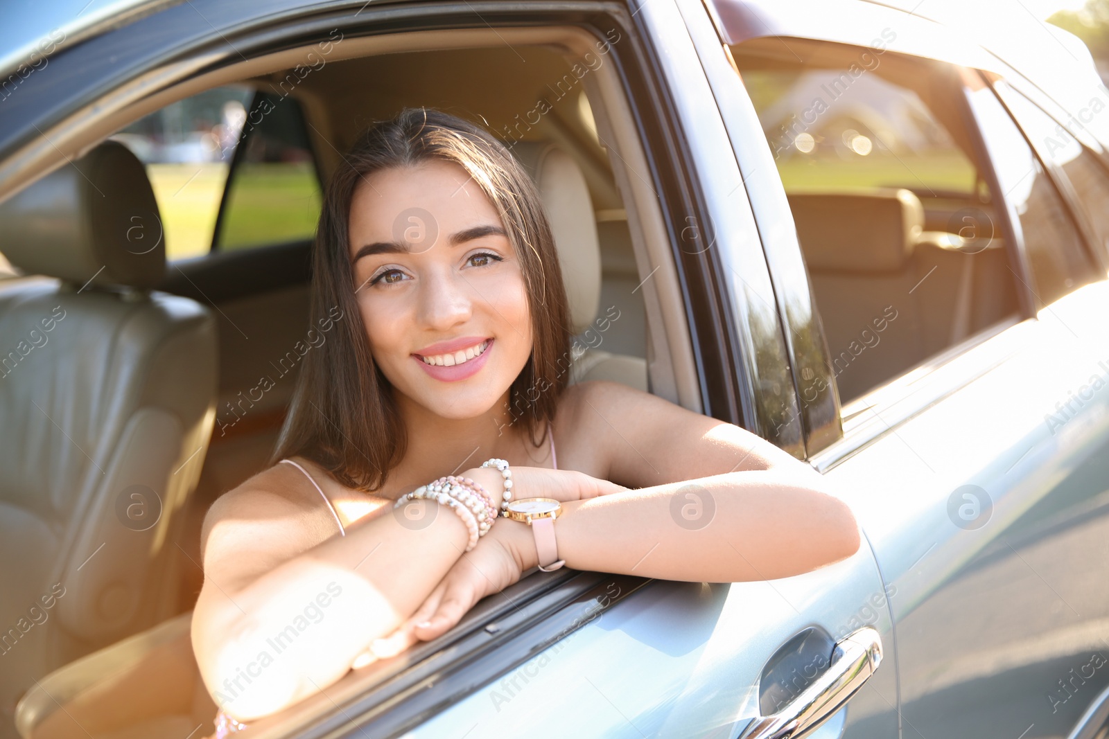 Photo of Young woman on driver's seat of car