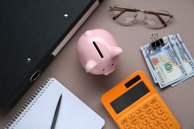 Photo of Flat lay composition with piggy bank, glasses and banknotes on grey background
