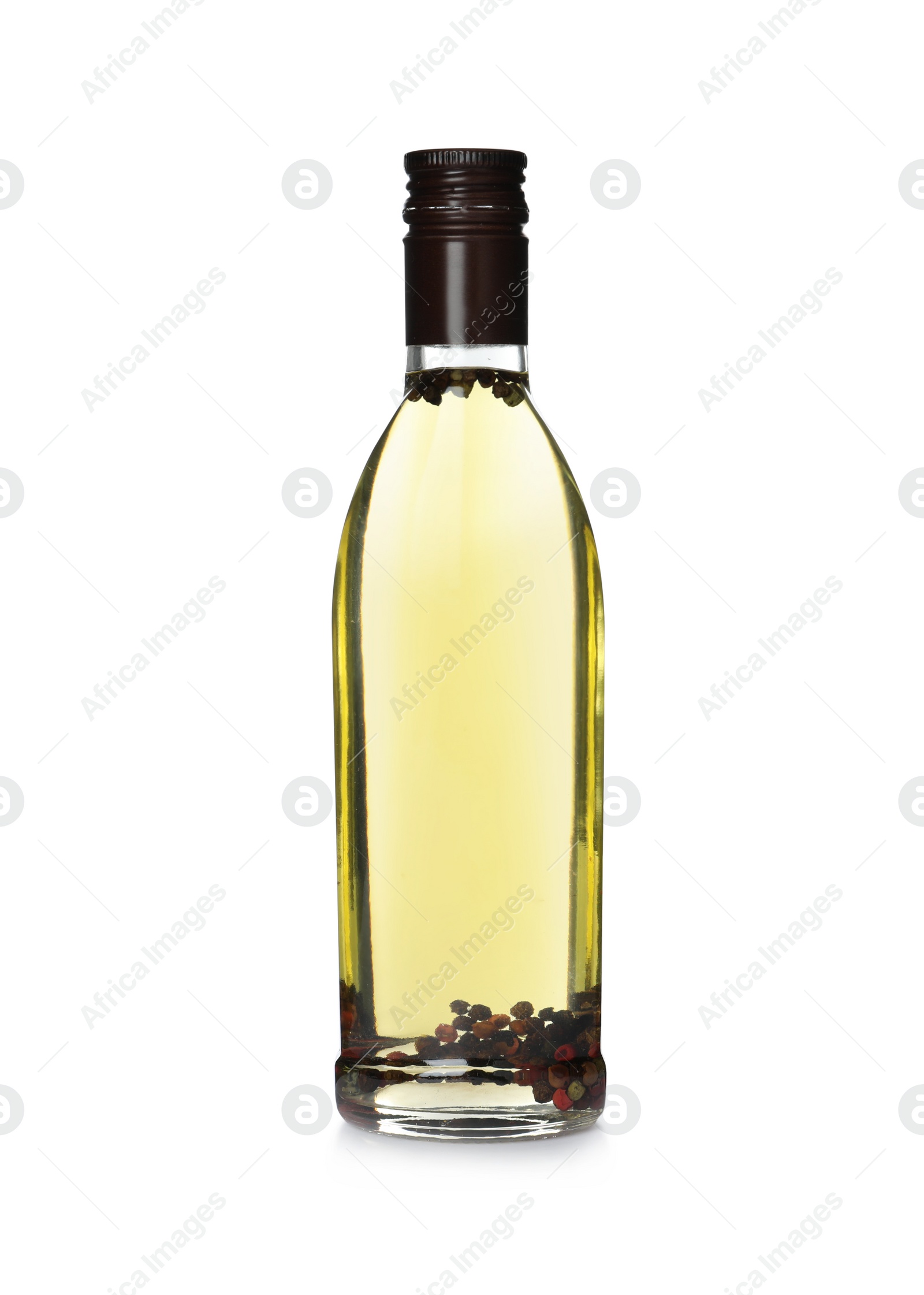 Photo of Cooking oil with peppercorns in glass bottle isolated on white