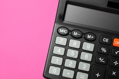 Calculator on pink background, top view. Space for text