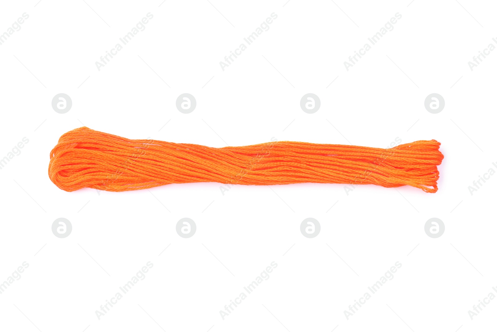 Photo of Bright orange embroidery thread on white background