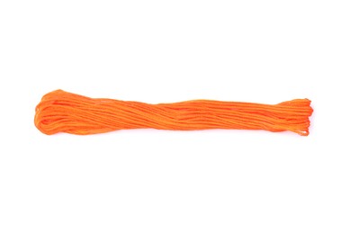 Photo of Bright orange embroidery thread on white background