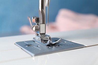 Photo of White sewing machine on light background, closeup