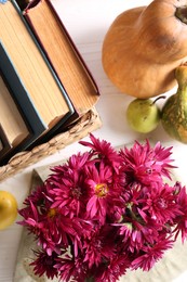 Photo of Autumn flat lay composition with beautiful chrysanthemum flowers and books on white wooden table