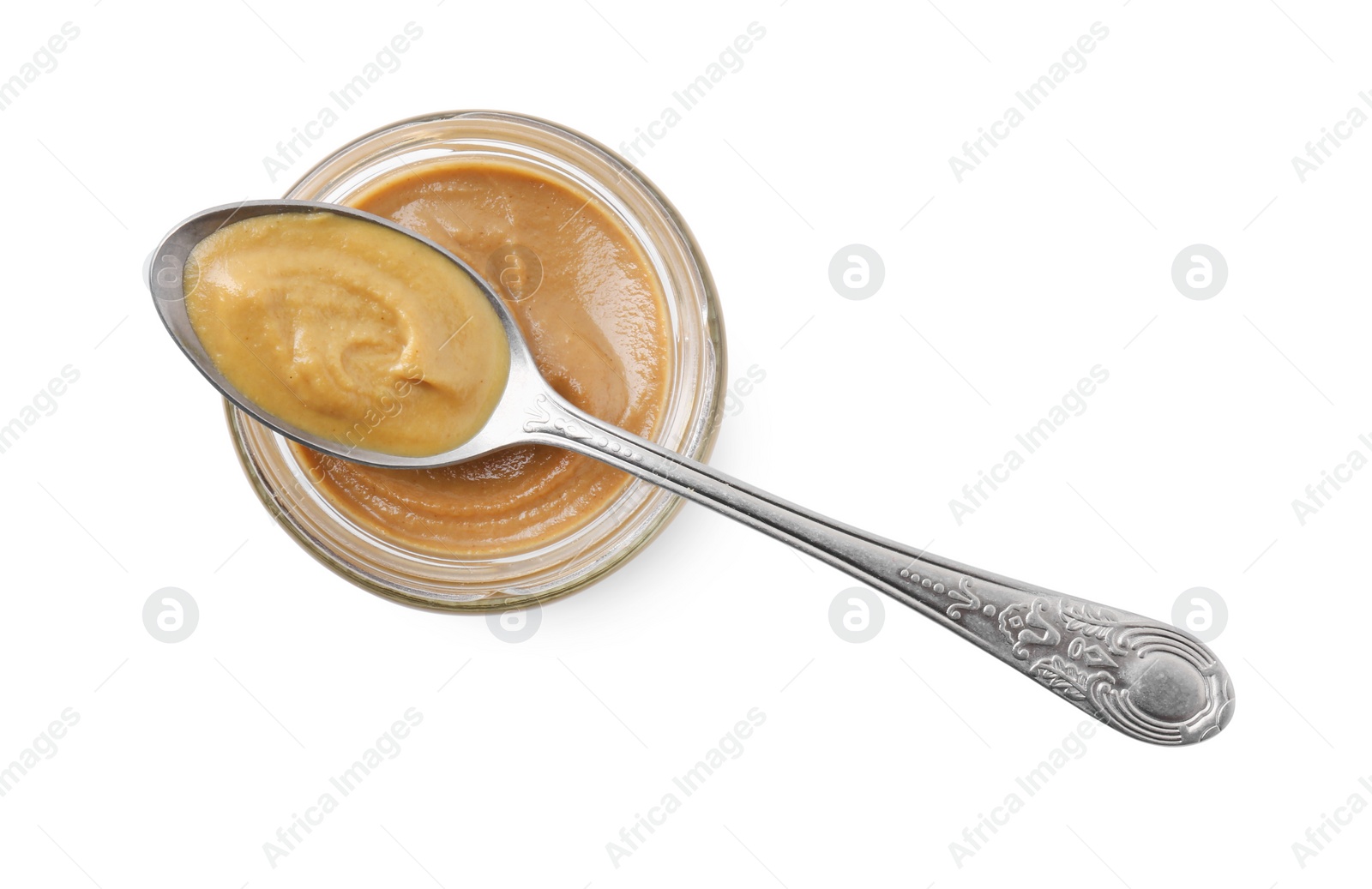 Photo of Fresh tasty mustard sauce in bowl and spoon isolated on white, top view