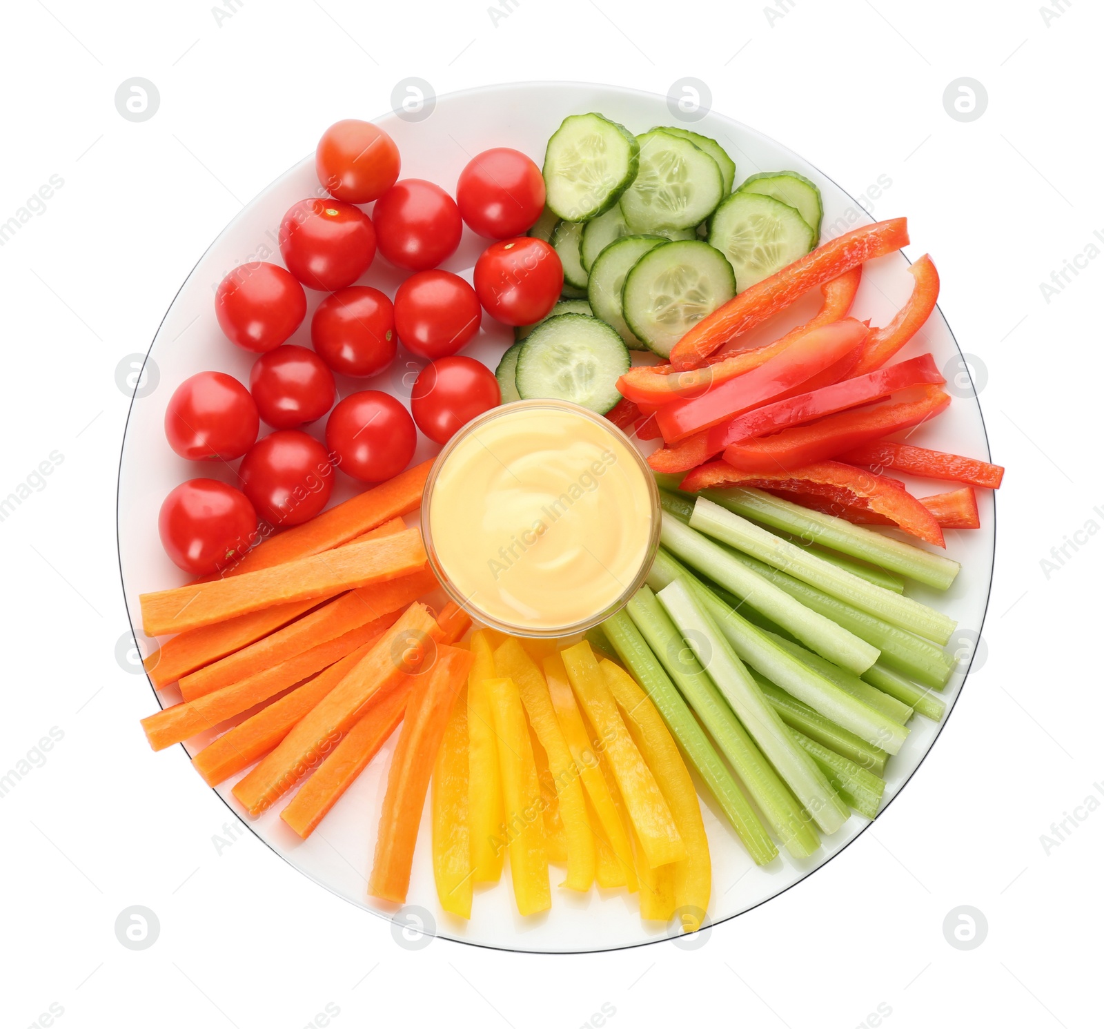 Photo of Plate with celery sticks, other vegetables and dip sauce isolated on white, top view