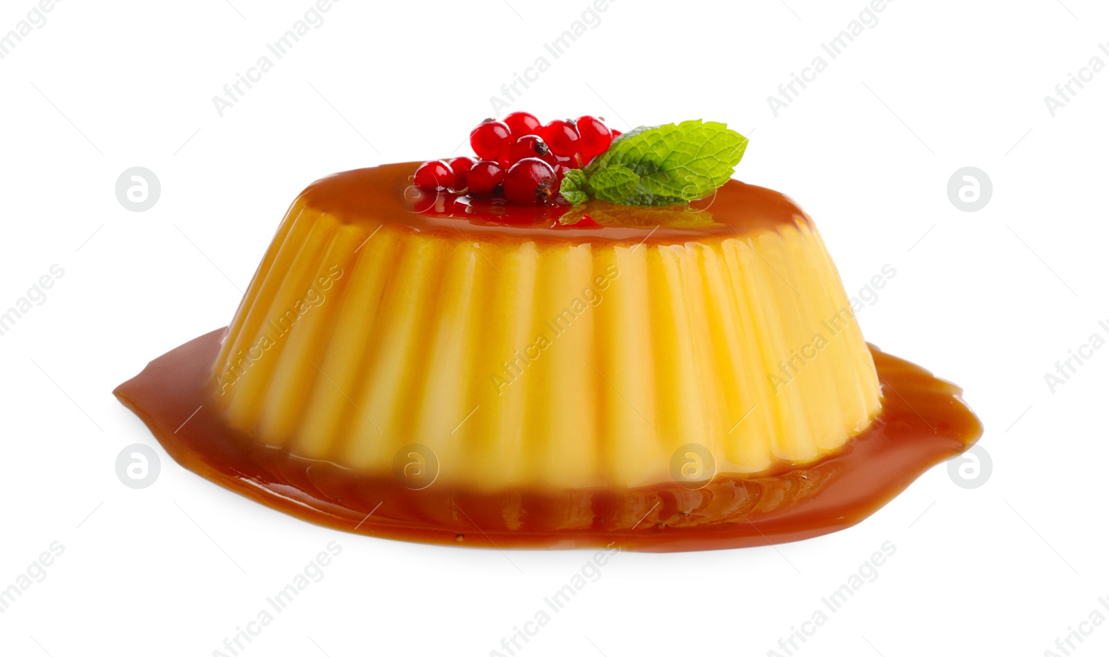 Photo of Delicious pudding with caramel, redcurrants and mint isolated on white