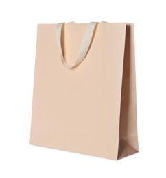 Photo of One beige shopping bag isolated on white