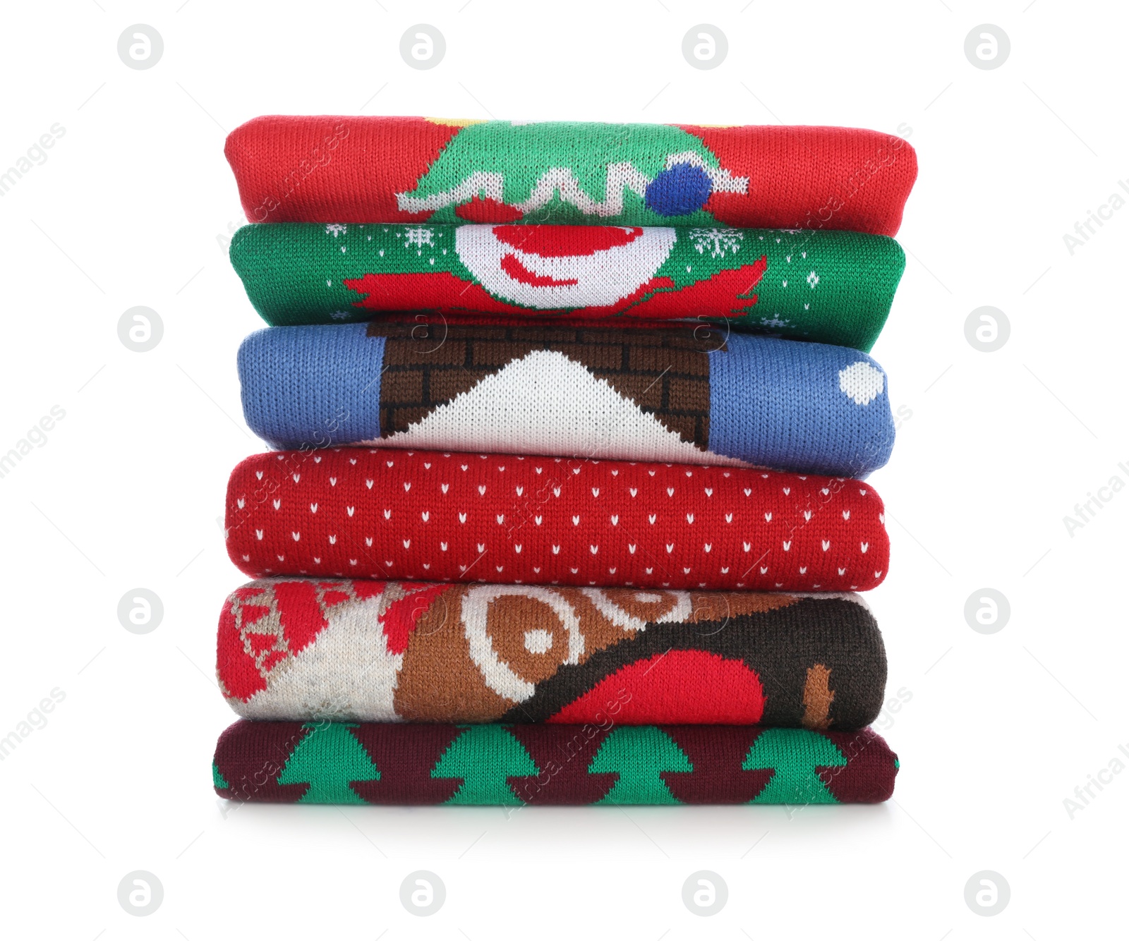 Photo of Stack of warm Christmas sweaters isolated on white