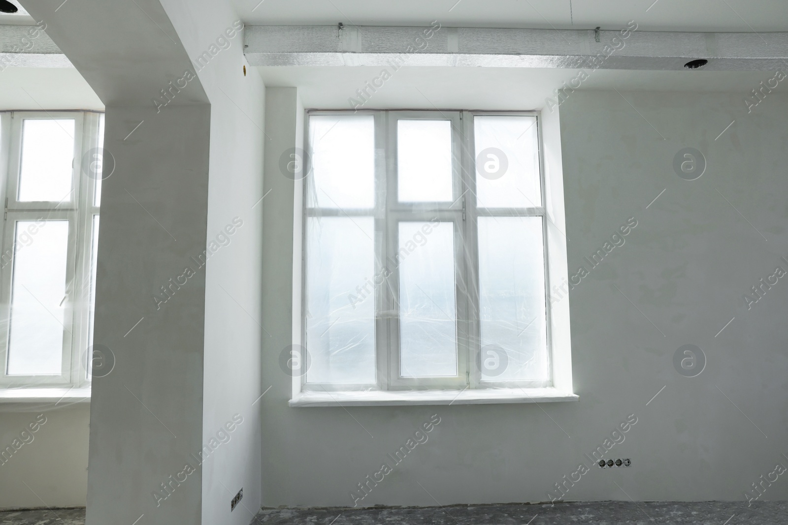 Photo of Windows covered with plastic film in spacious room