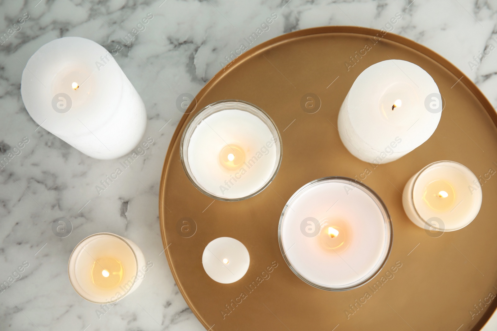 Photo of Flat lay composition with burning aromatic candles on marble table