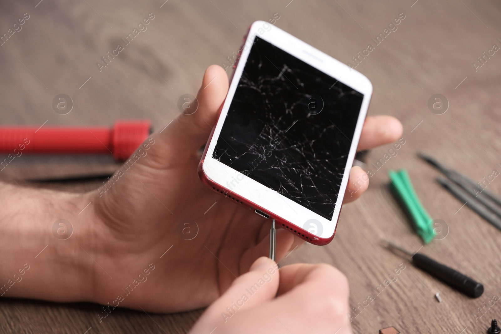 Photo of Technician fixing mobile phone at table, closeup. Device repair service