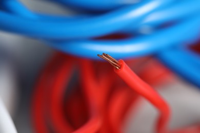 Photo of Red electrical wire on blurred background, closeup