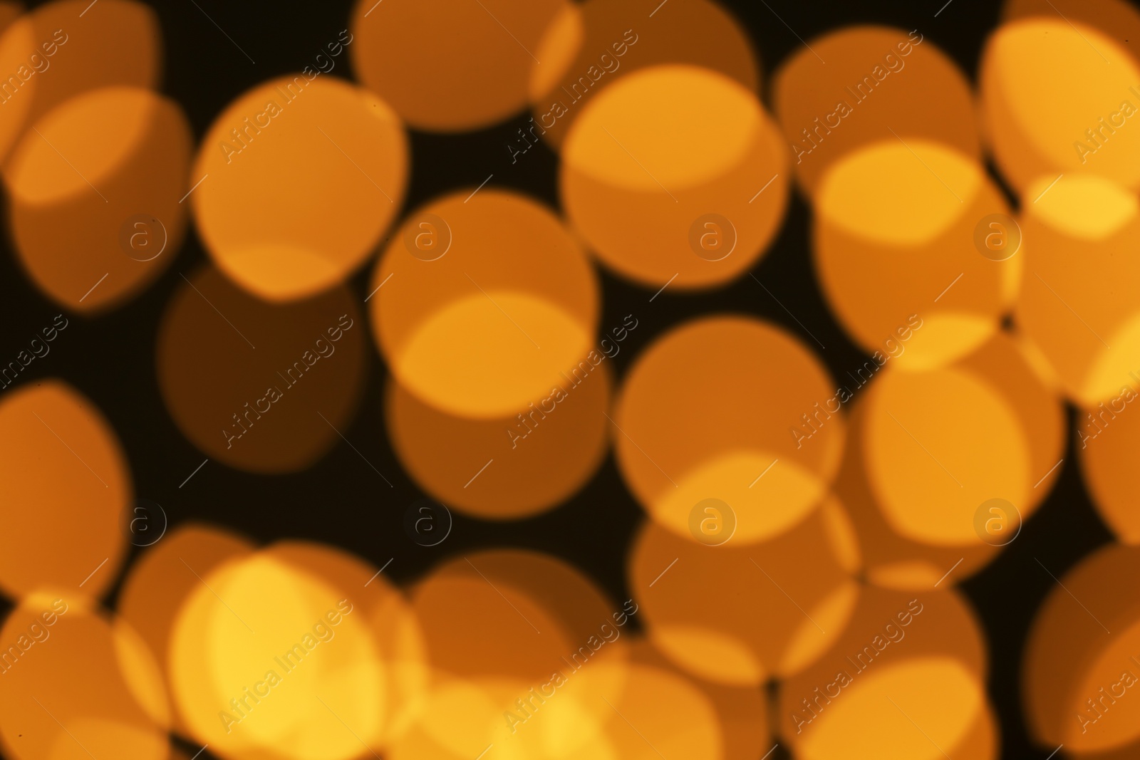 Photo of Beautiful golden lights on dark background. Bokeh effect