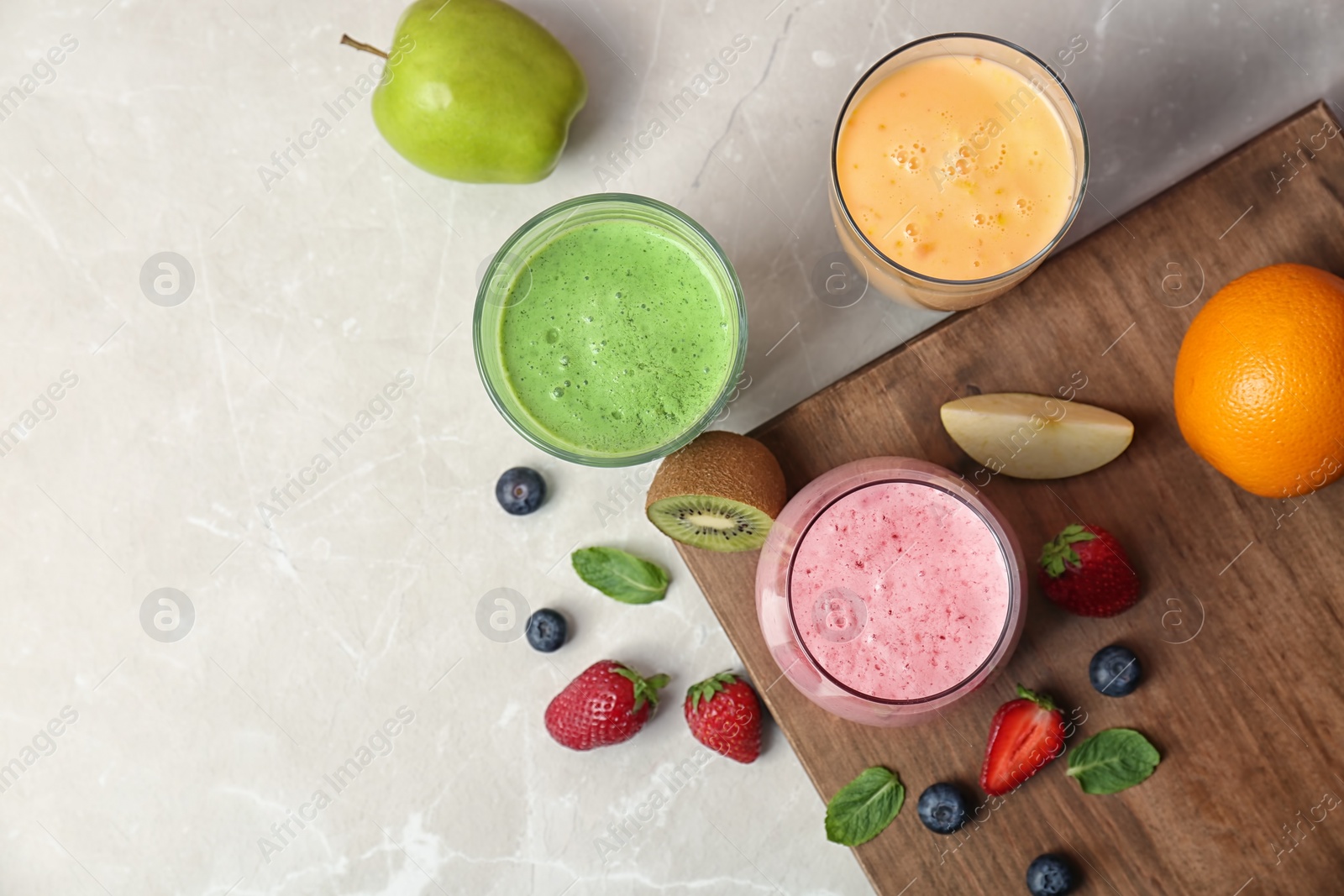 Photo of Flat lay composition with healthy detox smoothies and ingredients on light background