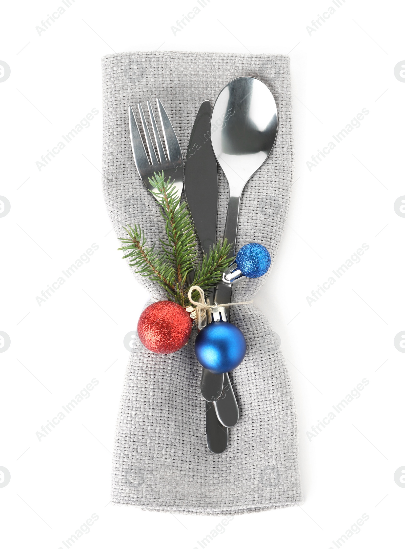 Photo of Cutlery, napkin and Christmas decor on white background, top view. Festive table setting