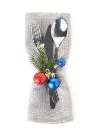 Cutlery, napkin and Christmas decor on white background, top view. Festive table setting