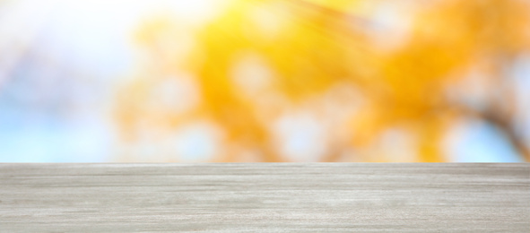 Empty wooden surface against blurred background. Bokeh effect