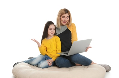 Photo of Mother and her daughter using video chat on laptop against white background