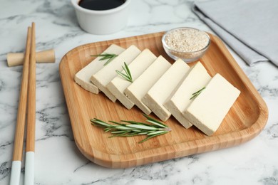Delicious tofu with rosemary served on white marble table