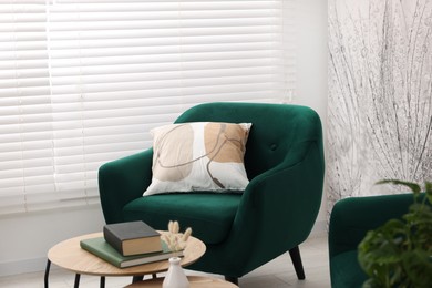 Photo of Comfortable armchair and nesting tables in stylish room