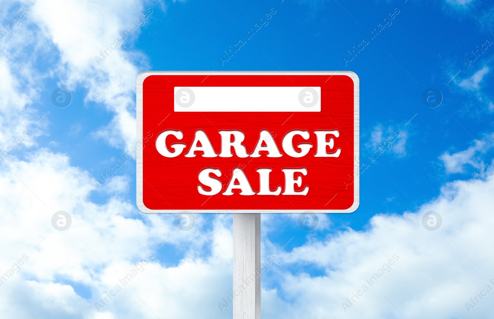 Image of Sign with phrase GARAGE SALE and blue sky 