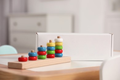 Stacking and counting game wooden pieces on table indoors. Educational toy for motor skills development