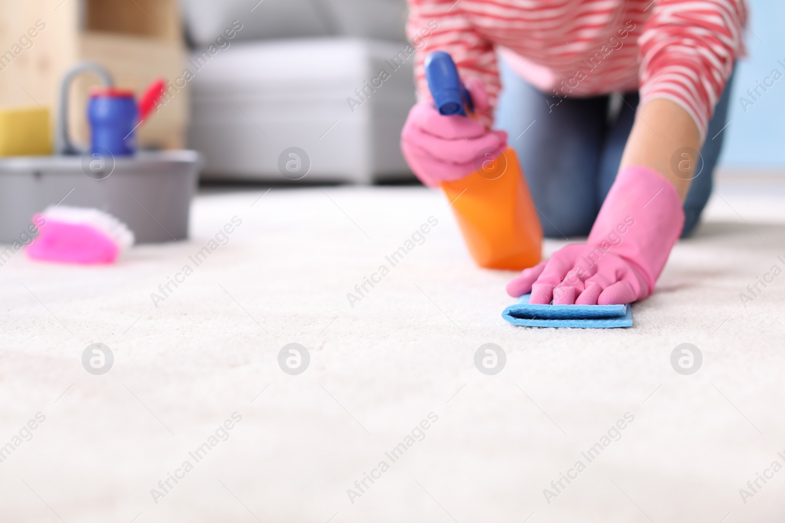 Photo of Woman cleaning carpet at home