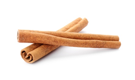 Photo of Aromatic cinnamon sticks on white background