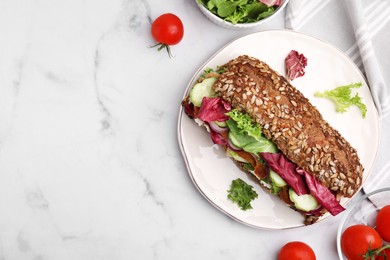 Delicious sandwich with schnitzel and ingredients on white marble table, flat lay. Space for text