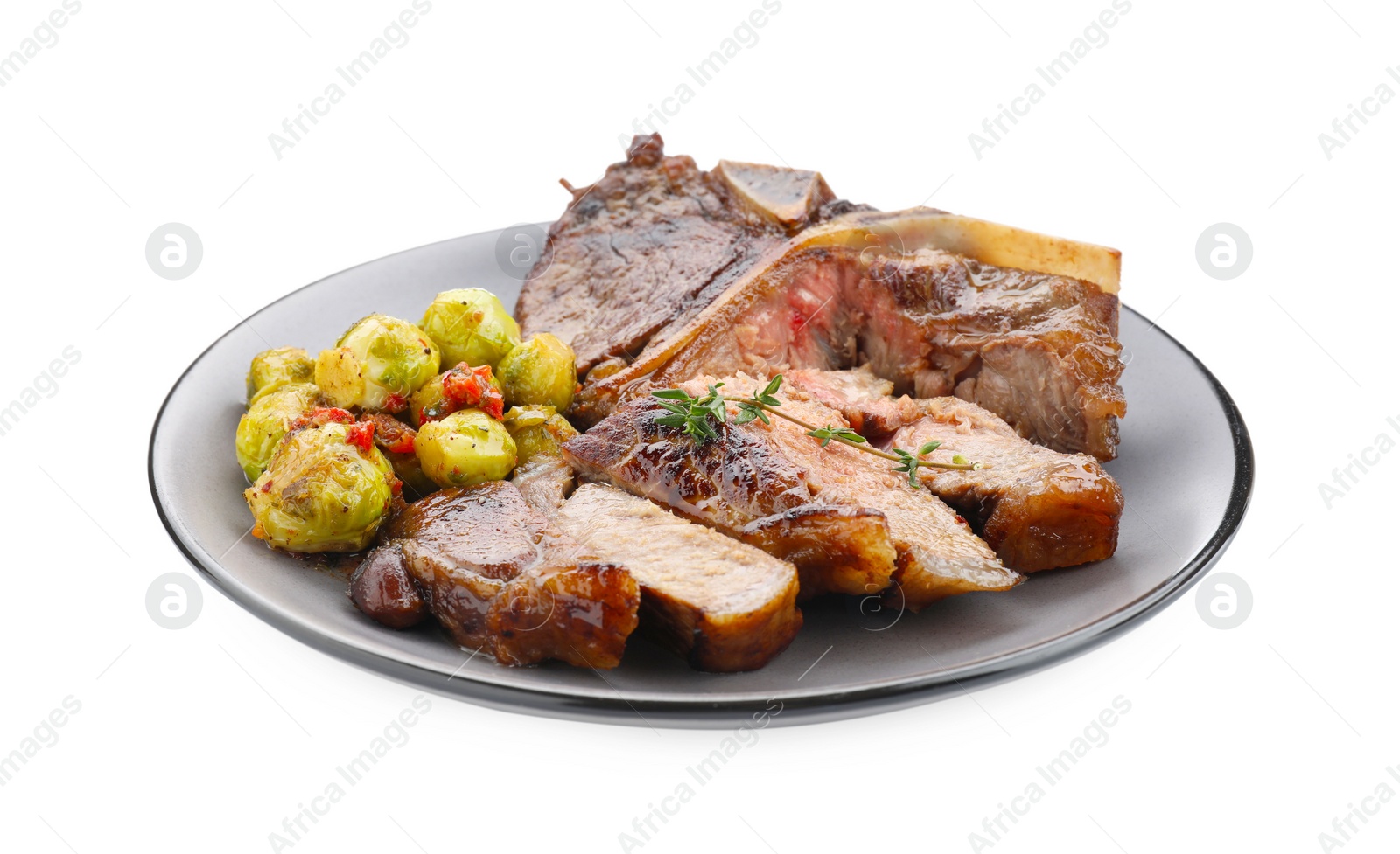 Photo of Delicious fried beef meat, vegetables and thyme isolated on white