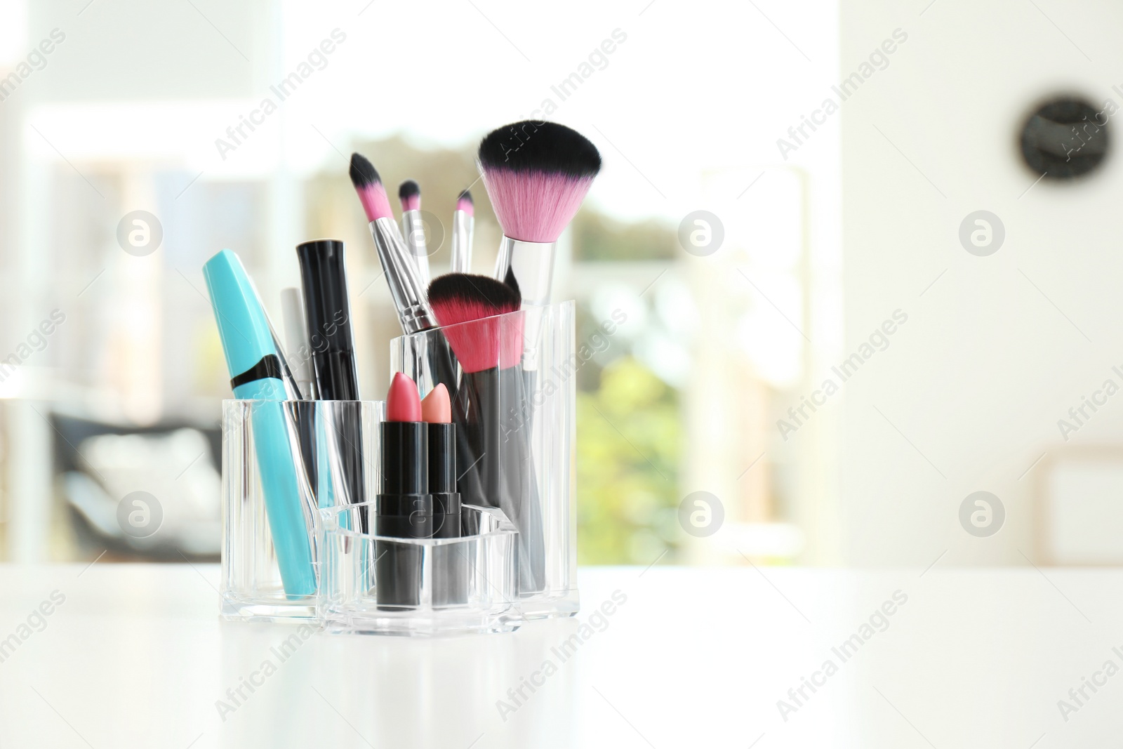 Photo of Organizer with makeup cosmetic products on table indoors. Space for text