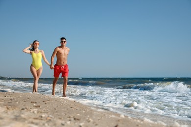 Photo of Lovely couple spending time together on beach