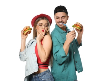 Happy couple with tasty burgers isolated on white