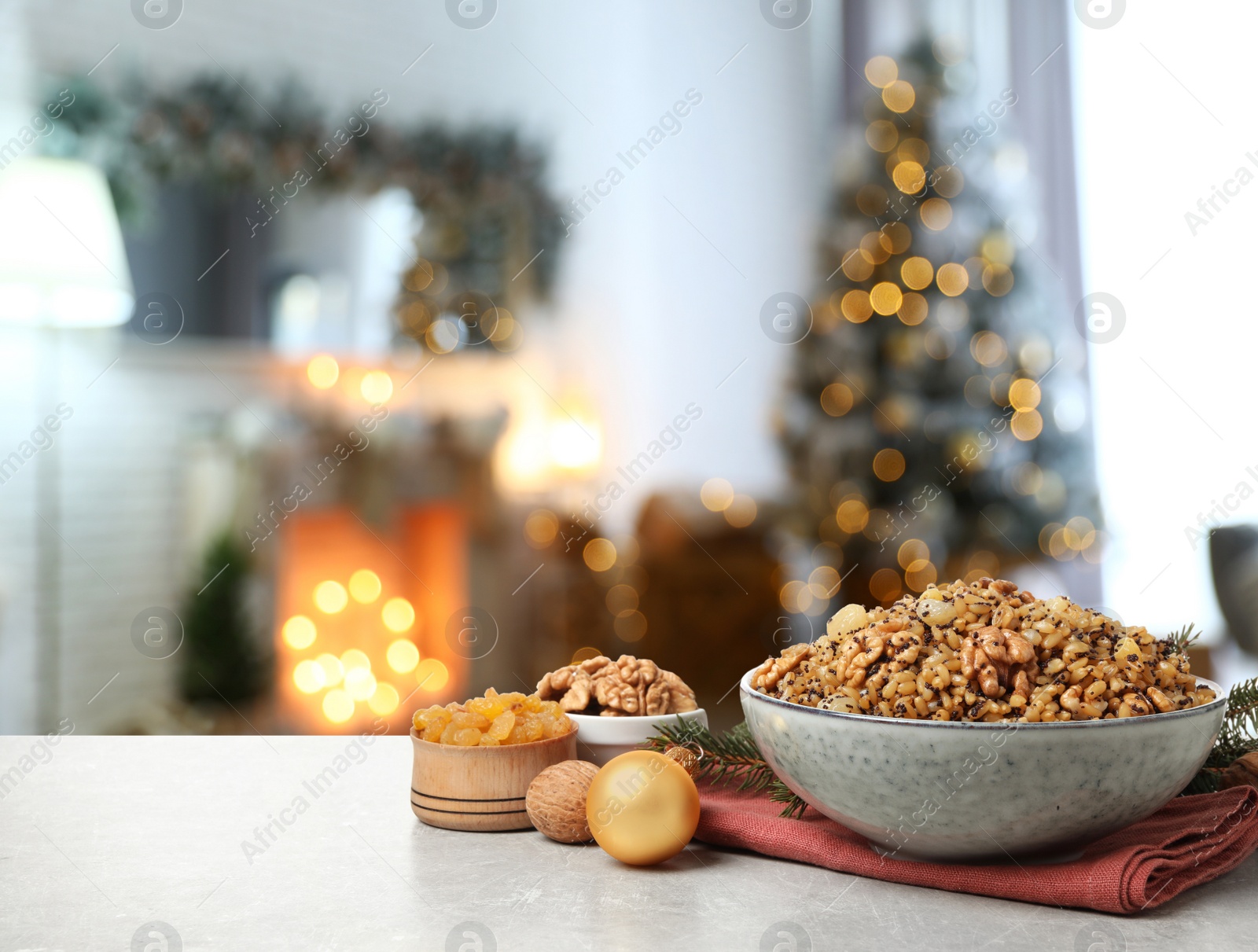 Image of Traditional Christmas slavic dish kutia on table in decorated room. Space for text