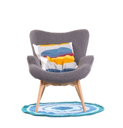 Photo of Comfortable armchair with pillow on white background. Interior element