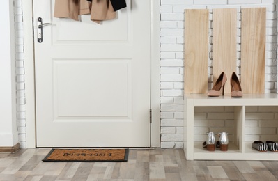 Photo of Hallway interior with shoe rack and mat near door