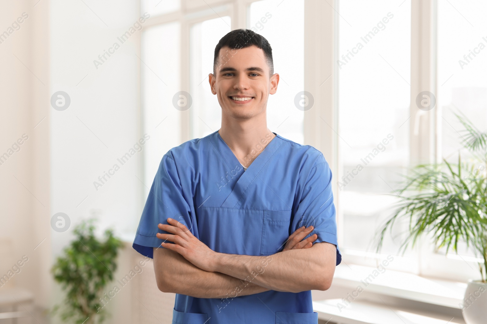 Photo of Portrait of smiling medical assistant with crossed arms in hospital