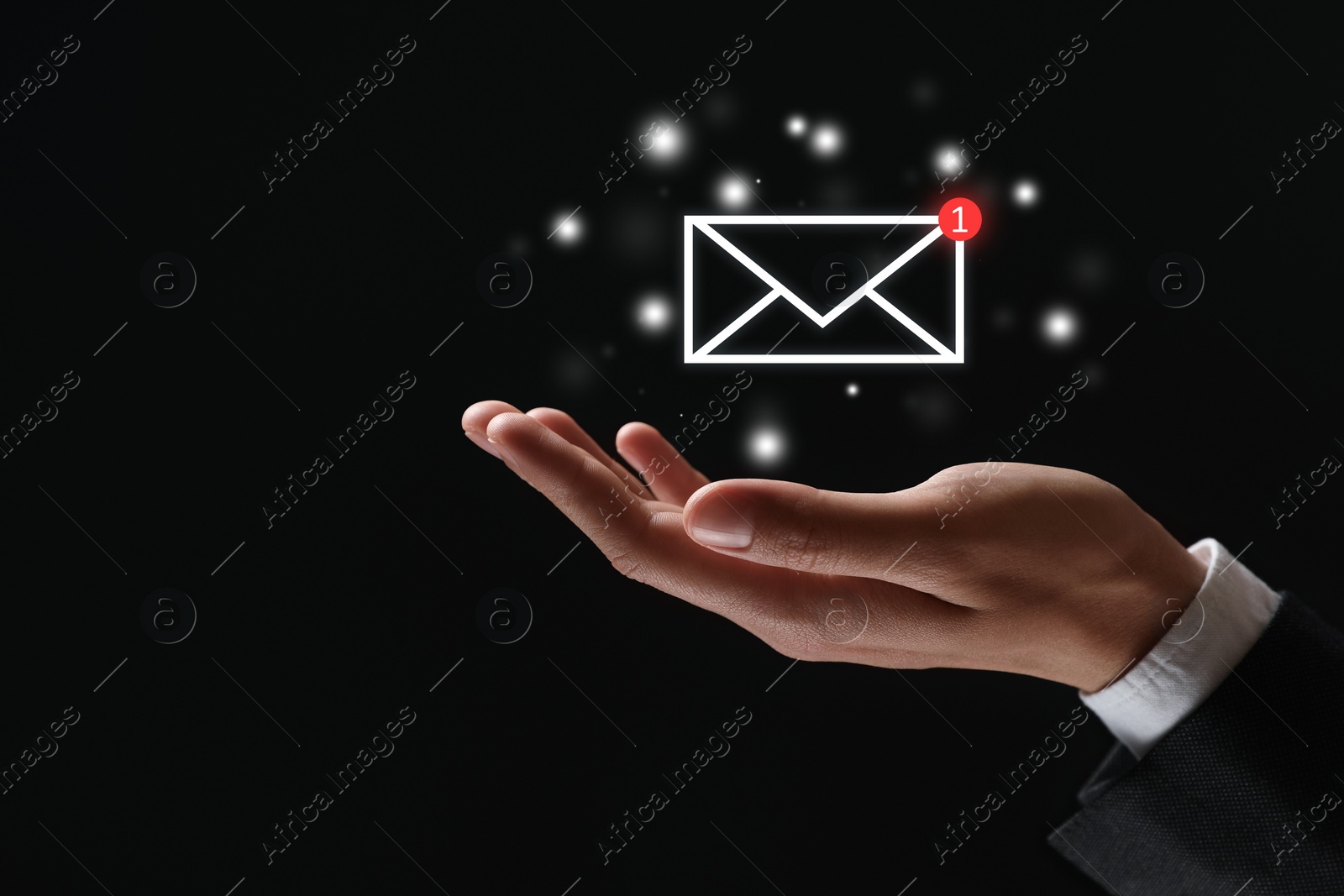 Image of Incoming email. Man holding virtual envelope against black background, closeup