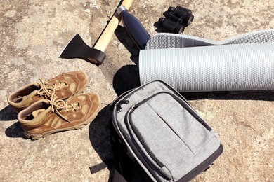 Set of camping equipment on rock outdoors, above view