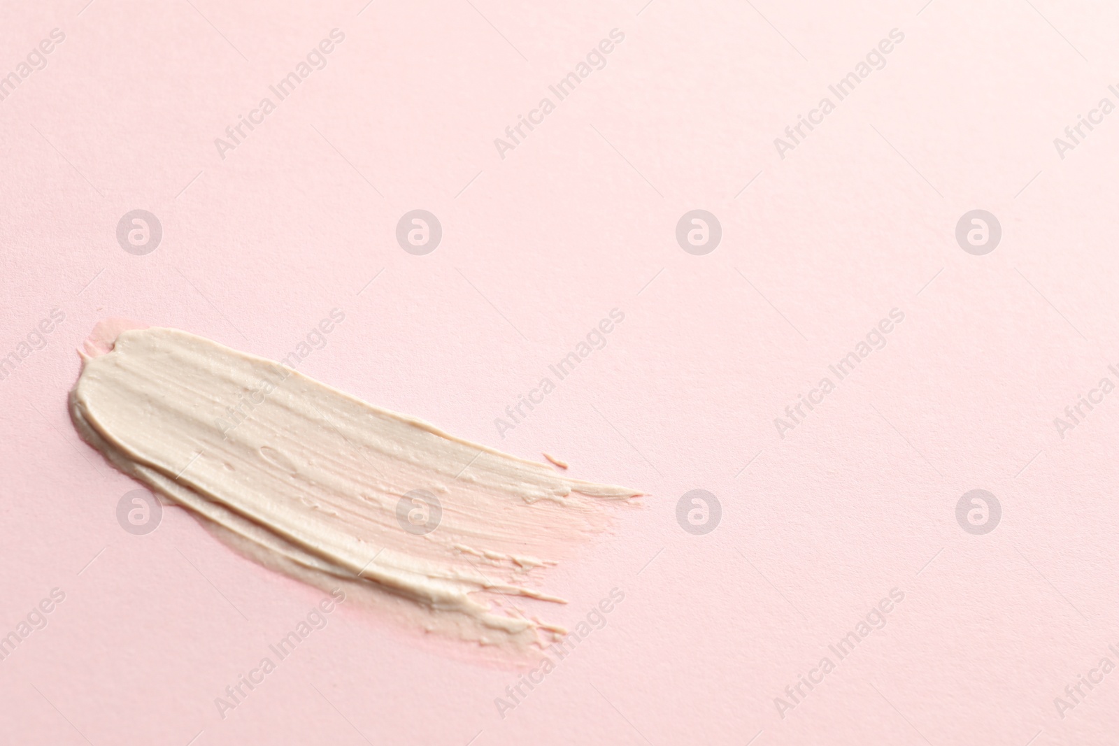 Photo of Sample of face mask on pink background, top view. Space for text