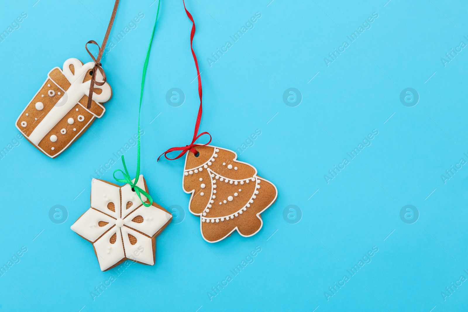 Photo of Different delicious Christmas cookies on light blue background, flat lay. Space for text