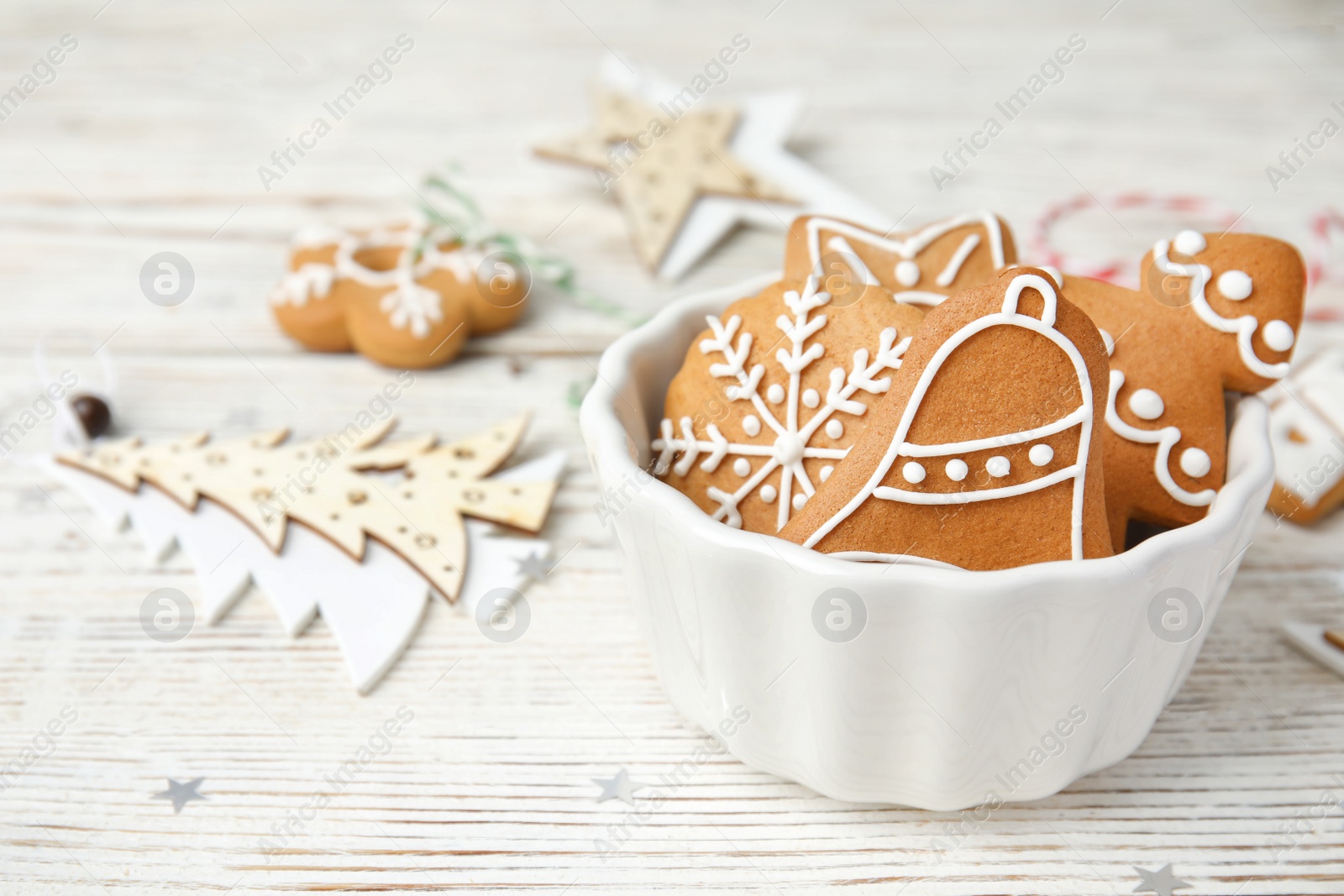 Photo of Bowl with tasty homemade Christmas cookies on table