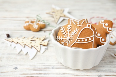 Photo of Bowl with tasty homemade Christmas cookies on table