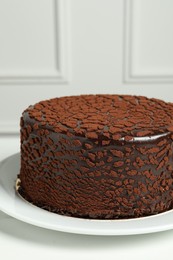 Delicious chocolate truffle cake on white table