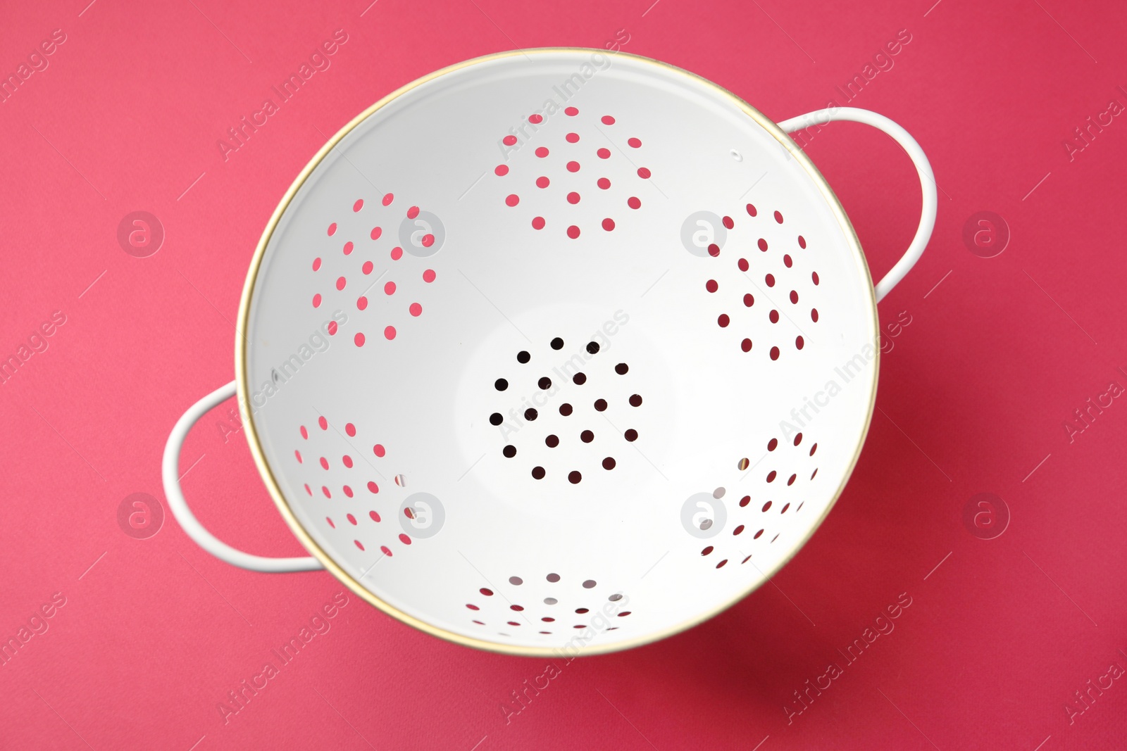 Photo of One clean empty colander on pink table, top view