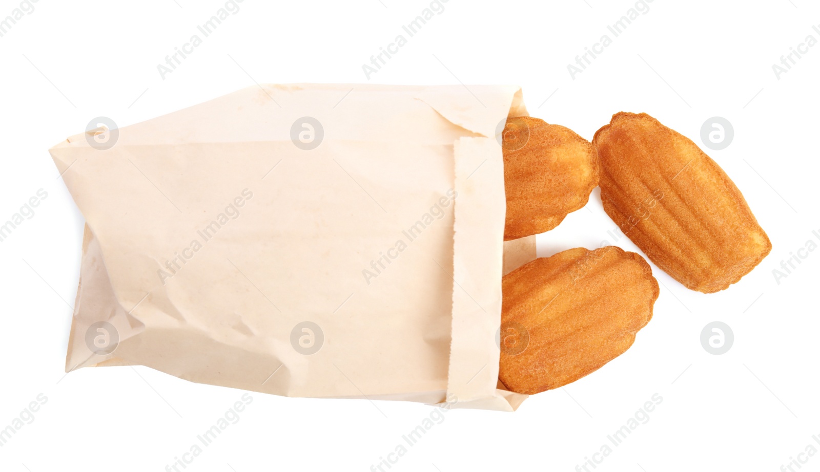 Photo of Paper bag with delicious madeleine cakes on white background, top view