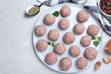 Photo of Many fresh raw meatballs on light table, flat lay. Space for text